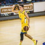 man in yellow jersey shirt playing basketball