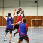 a group of young men playing a game of basketball