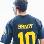 man in black and yellow nike 10 jersey shirt