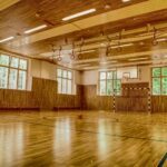 brown wooden parquet floor with white wall